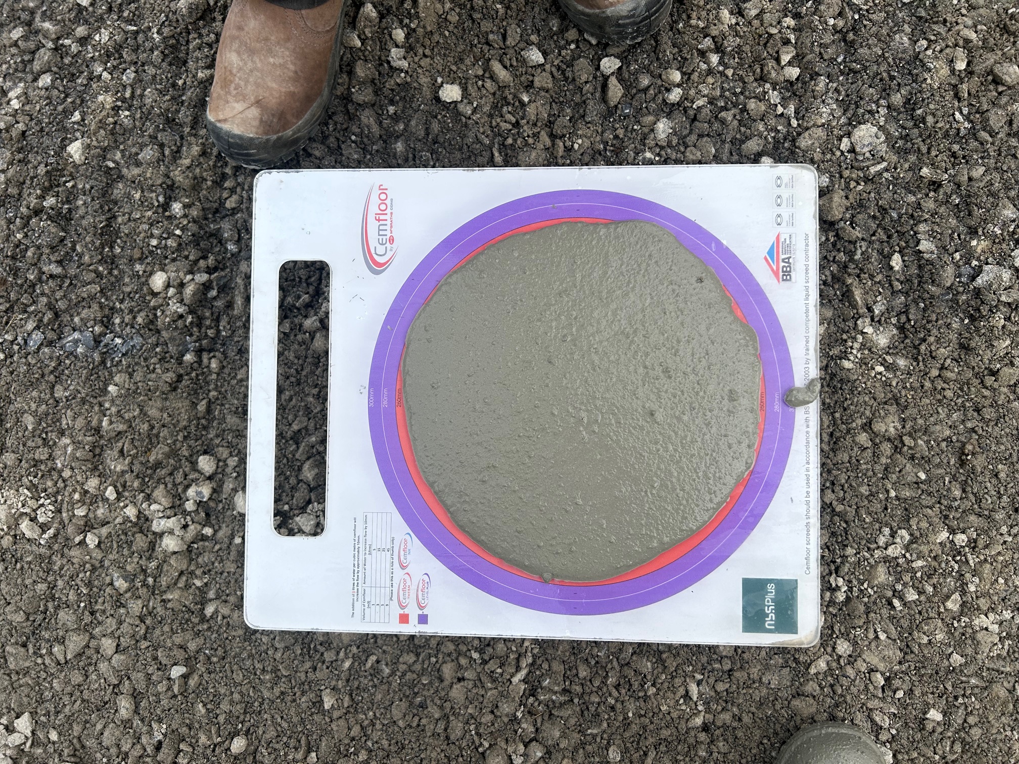 Cemfloor Slump Test — Ireland Cemfloor slump test board showing quality control testing with purple and red rings Ireland